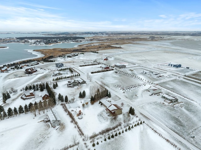 snowy aerial view with a water view