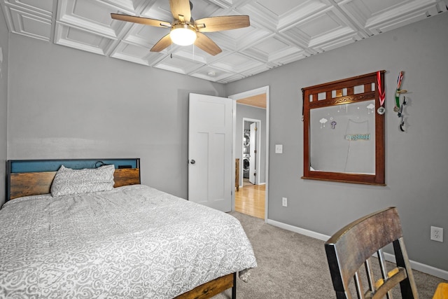 bedroom featuring beam ceiling, ceiling fan, coffered ceiling, crown molding, and light colored carpet