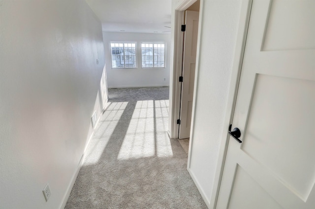 3308 23rd Ave NW, Minot, ND 58703 - hallway featuring light carpet