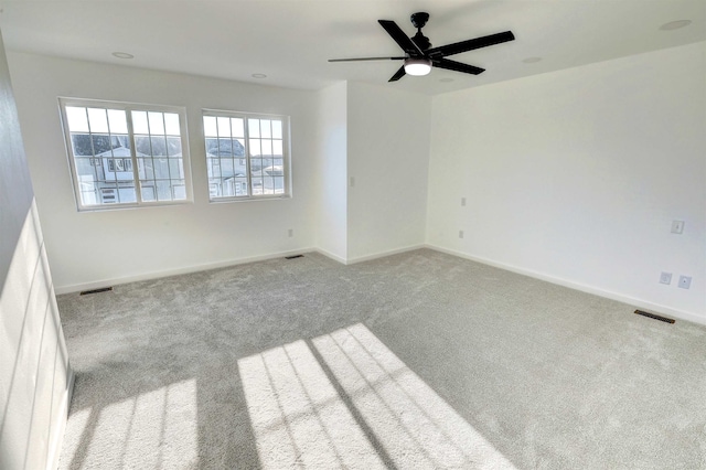 3308 23rd Ave NW, Minot, ND 58703 - spare room with light colored carpet and ceiling fan