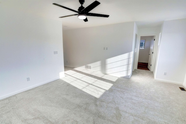 3308 23rd Ave NW, Minot, ND 58703 - empty room featuring ceiling fan and light colored carpet