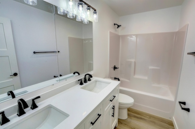 3308 23rd Ave NW, Minot, ND 58703 - full bathroom featuring vanity, shower / bathing tub combination, wood-type flooring, and toilet