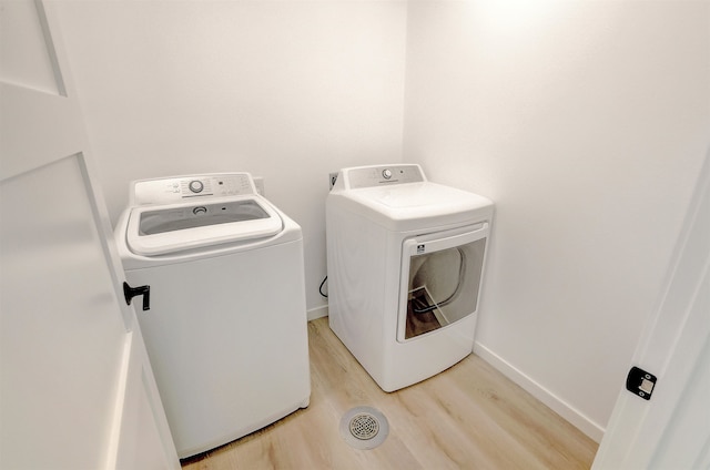 3308 23rd Ave NW, Minot, ND 58703 - washroom with separate washer and dryer and light hardwood / wood-style floors