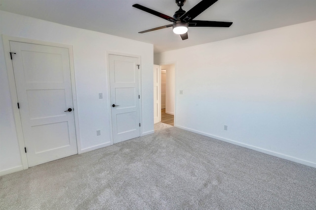 3308 23rd Ave NW, Minot, ND 58703 - unfurnished bedroom with light colored carpet and ceiling fan