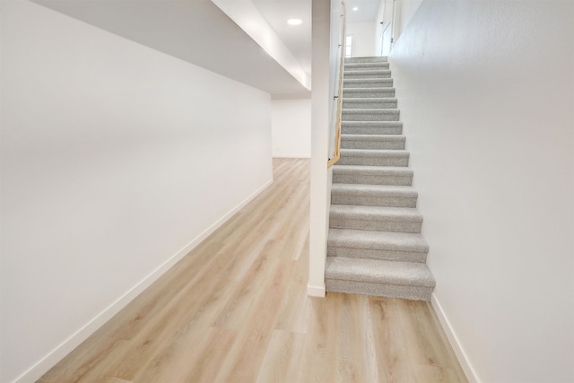 3308 23rd Ave NW, Minot, ND 58703 - staircase featuring wood-type flooring