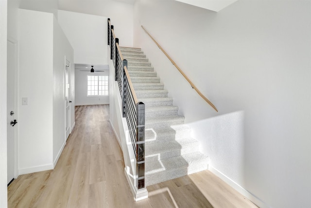 3308 23rd Ave NW, Minot, ND 58703 - stairs featuring hardwood / wood-style floors and ceiling fan