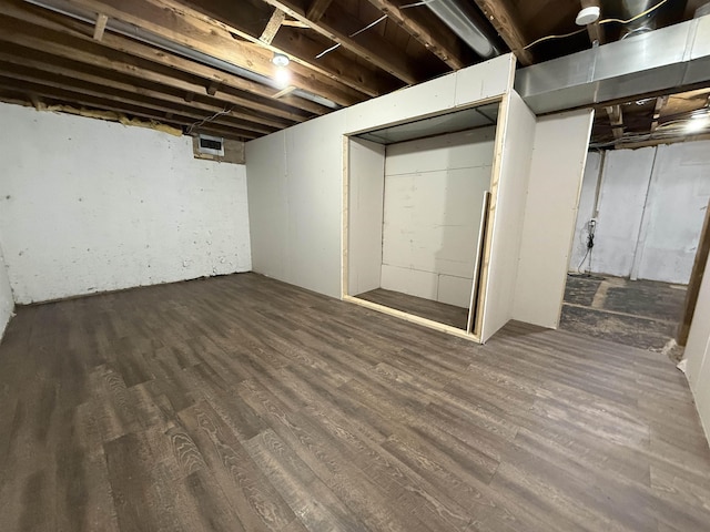 basement featuring dark hardwood / wood-style floors