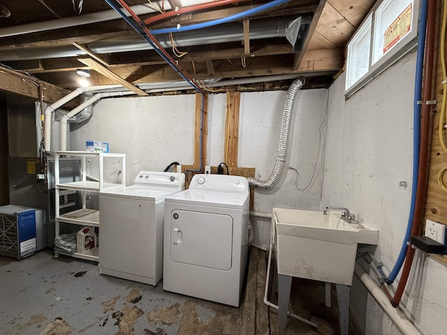 washroom with separate washer and dryer and sink