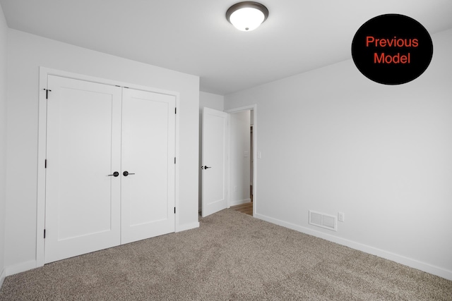 unfurnished bedroom with a closet and carpet floors