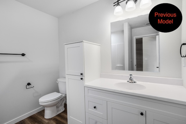 bathroom featuring hardwood / wood-style flooring, vanity, and toilet