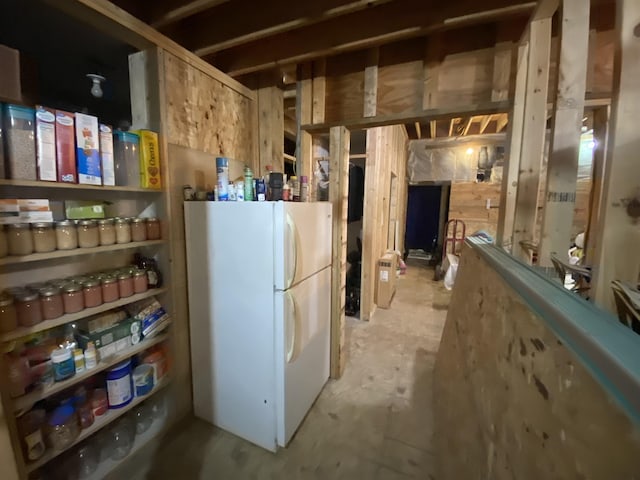 basement featuring white fridge