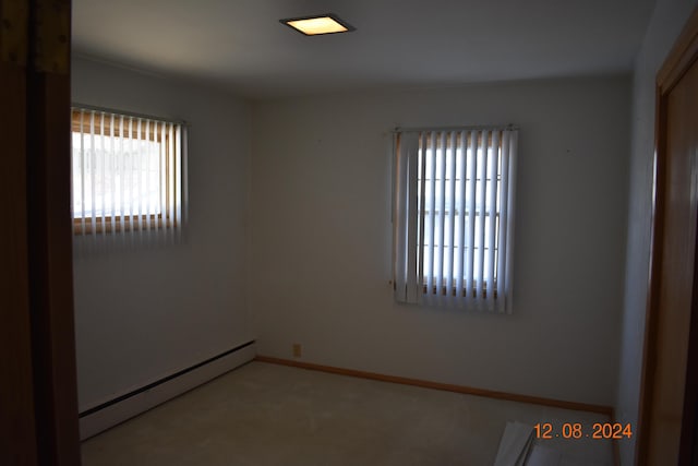 spare room with plenty of natural light and a baseboard heating unit