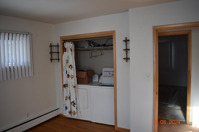 washroom featuring washer and clothes dryer, wood-type flooring, and a baseboard heating unit