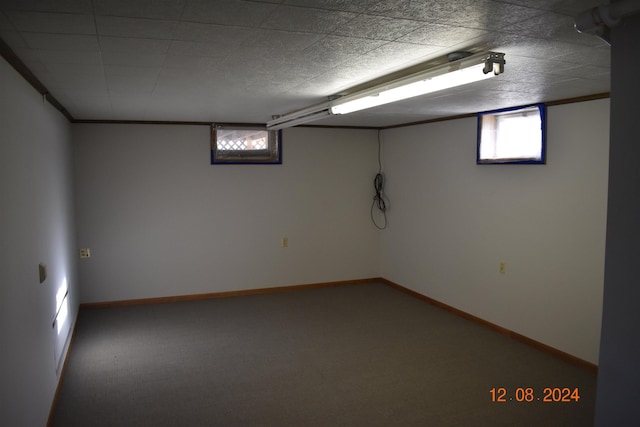 basement with carpet flooring and crown molding