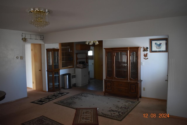 interior space with carpet flooring and an inviting chandelier