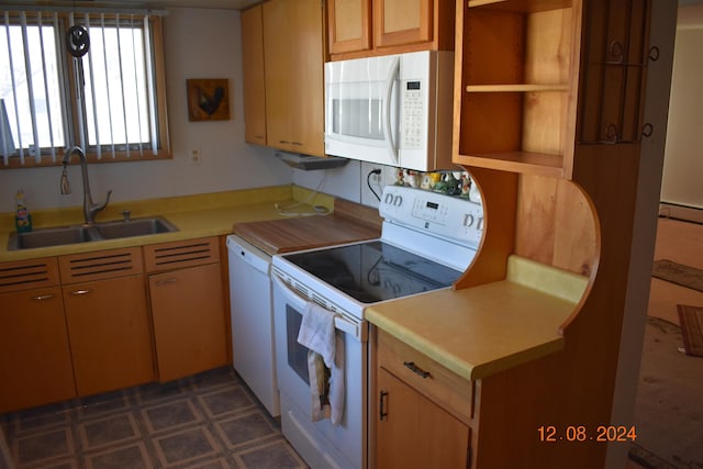 kitchen featuring white appliances, sink, and a baseboard heating unit