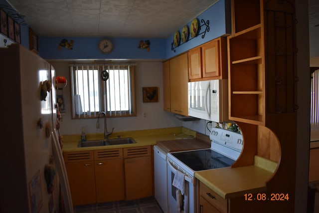 kitchen featuring sink and white appliances