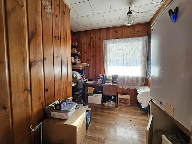 office space featuring wood walls and wood-type flooring