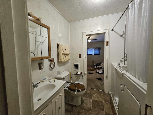 full bathroom featuring shower / tub combo, vanity, toilet, and tile walls