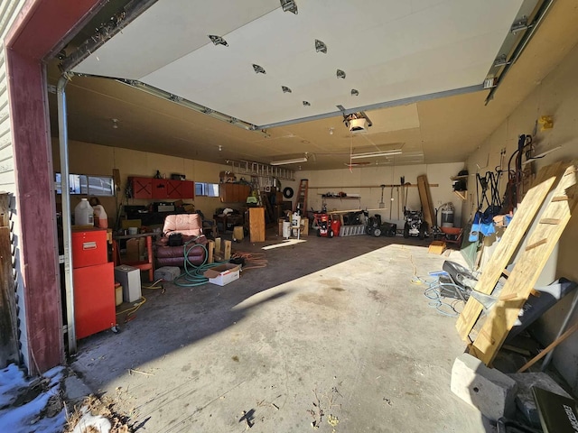 garage with a workshop area and a garage door opener