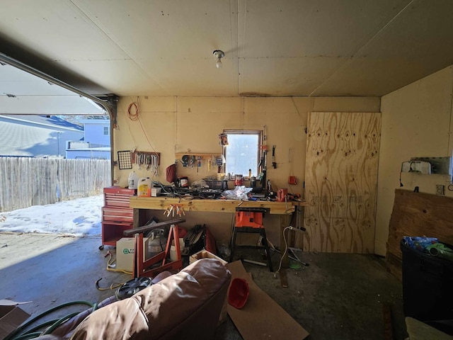 misc room featuring a workshop area and concrete floors