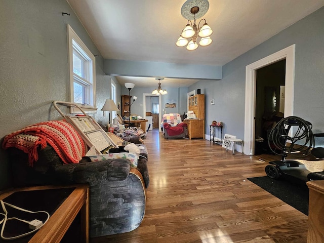 living room featuring hardwood / wood-style flooring and a chandelier