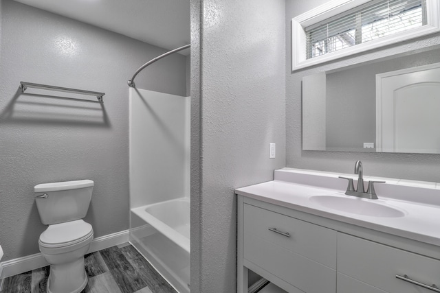 full bathroom with vanity,  shower combination, toilet, and wood-type flooring