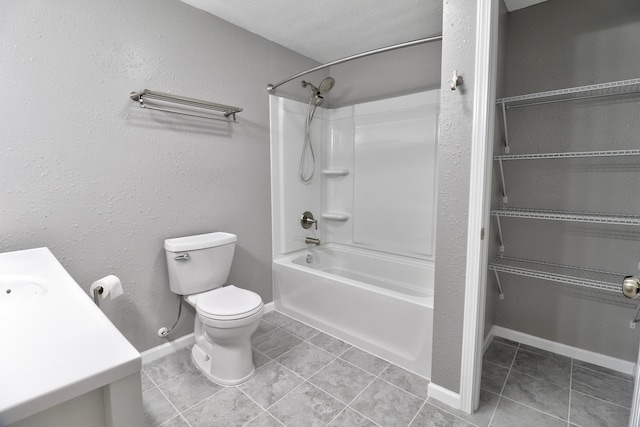 full bathroom featuring vanity,  shower combination, a textured ceiling, tile patterned flooring, and toilet