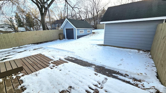 snow covered deck with a storage shed