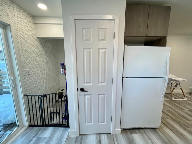 kitchen with white fridge and light hardwood / wood-style flooring