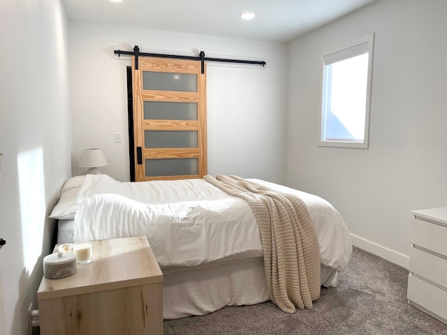 carpeted bedroom with a barn door