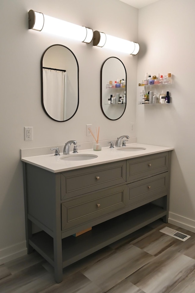 bathroom with hardwood / wood-style floors and vanity