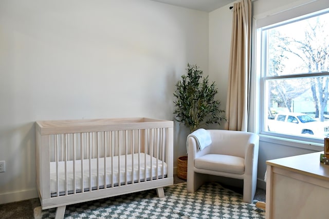 carpeted bedroom with a nursery area