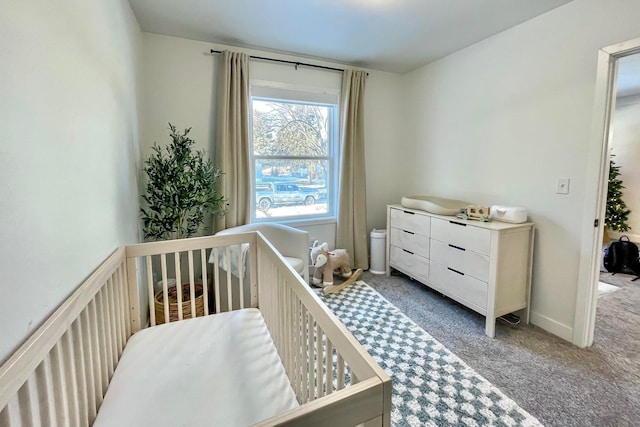 bedroom featuring carpet flooring and a crib