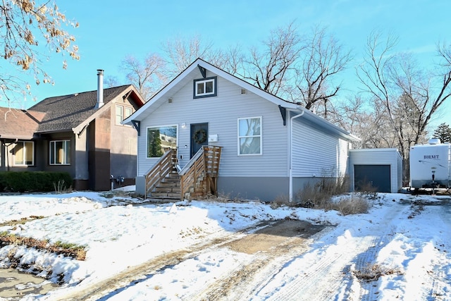 bungalow-style home featuring an outbuilding and a garage