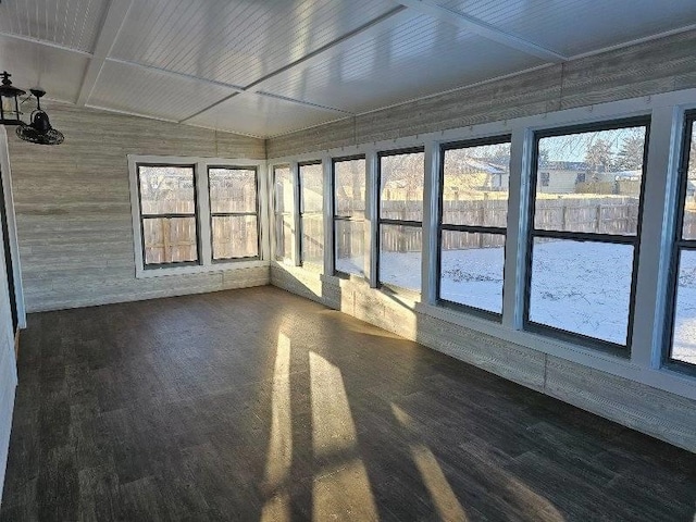 unfurnished sunroom featuring a wealth of natural light and lofted ceiling