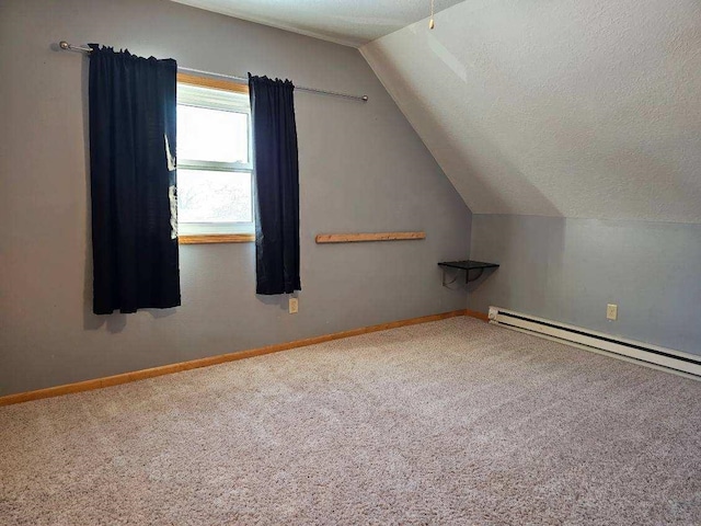 bonus room featuring vaulted ceiling, carpet, a textured ceiling, and a baseboard heating unit