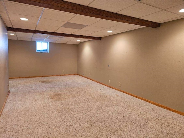 basement with carpet flooring and a drop ceiling