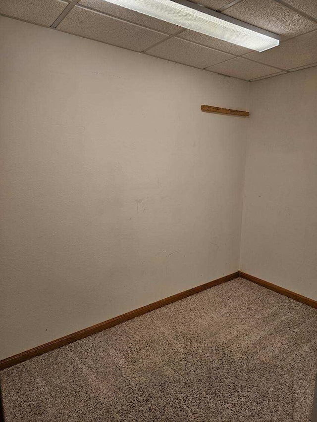 empty room with carpet and a drop ceiling