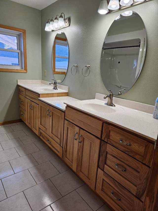 bathroom featuring tile patterned flooring and vanity