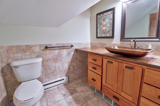 bathroom with vanity, a baseboard radiator, toilet, and tile walls