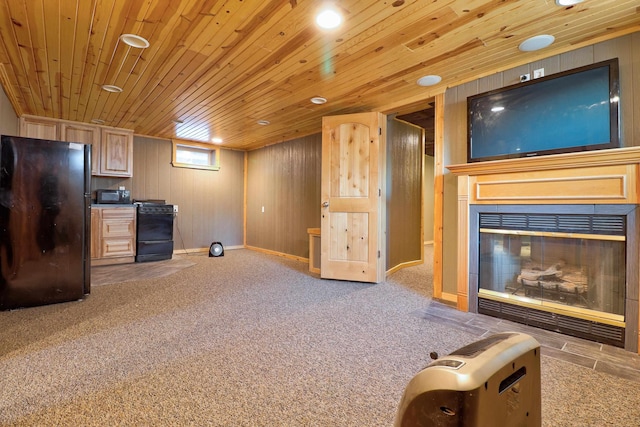 interior space featuring carpet flooring, wood walls, and wooden ceiling