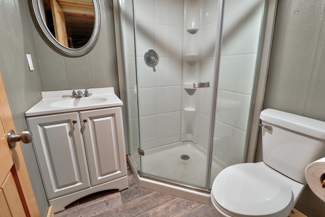 bathroom with vanity, wood-type flooring, an enclosed shower, and toilet