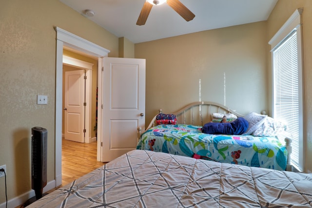 bedroom with ceiling fan and hardwood / wood-style flooring