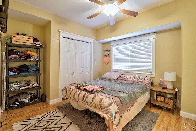 bedroom featuring light hardwood / wood-style floors, a closet, and ceiling fan