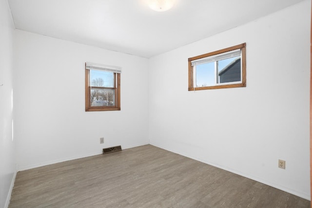 unfurnished room featuring hardwood / wood-style flooring