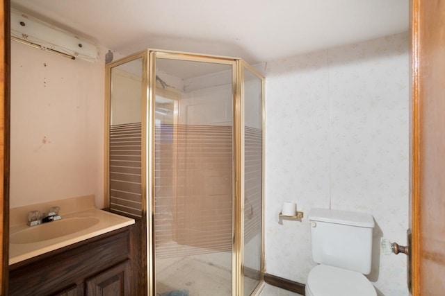 bathroom with vanity, an enclosed shower, and toilet