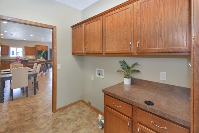 clothes washing area with cabinets and washer hookup