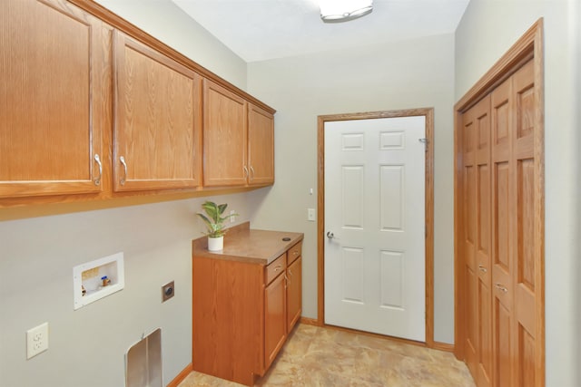 clothes washing area featuring hookup for an electric dryer, cabinets, and washer hookup