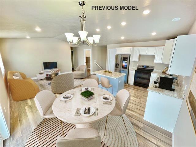 dining room with light hardwood / wood-style floors and a notable chandelier